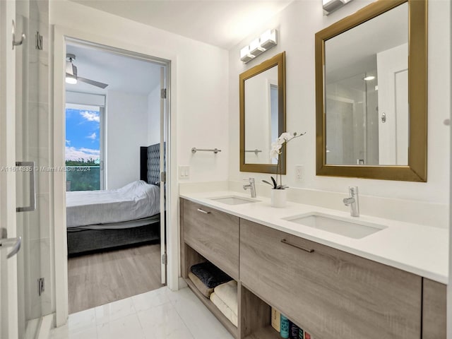 bathroom featuring walk in shower, vanity, wood-type flooring, and ceiling fan