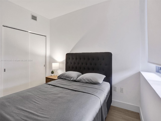 bedroom featuring a closet and light hardwood / wood-style flooring