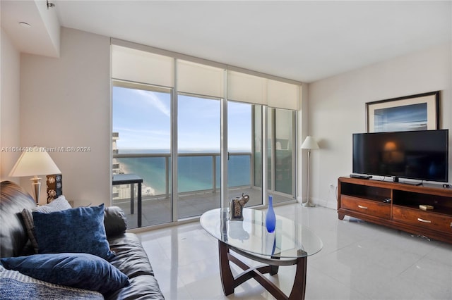 tiled living room featuring floor to ceiling windows