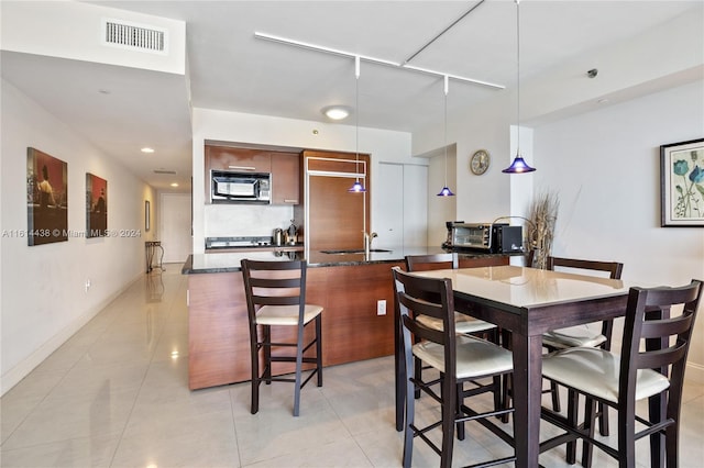 dining room with sink and light tile patterned floors