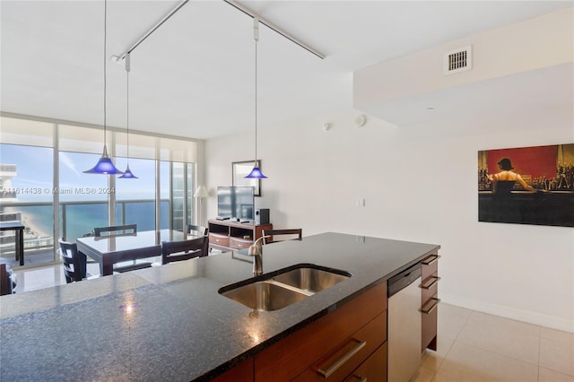 kitchen with dishwasher, sink, expansive windows, and decorative light fixtures