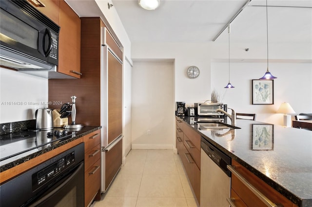 kitchen featuring sink, tasteful backsplash, pendant lighting, light tile patterned floors, and black appliances