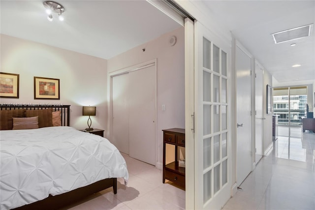 tiled bedroom with a closet