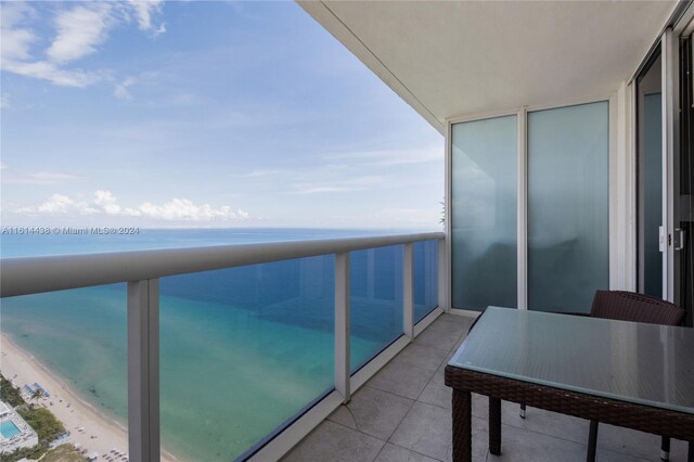 balcony with a beach view and a water view