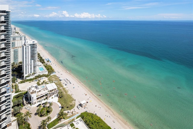 bird's eye view featuring a water view and a beach view