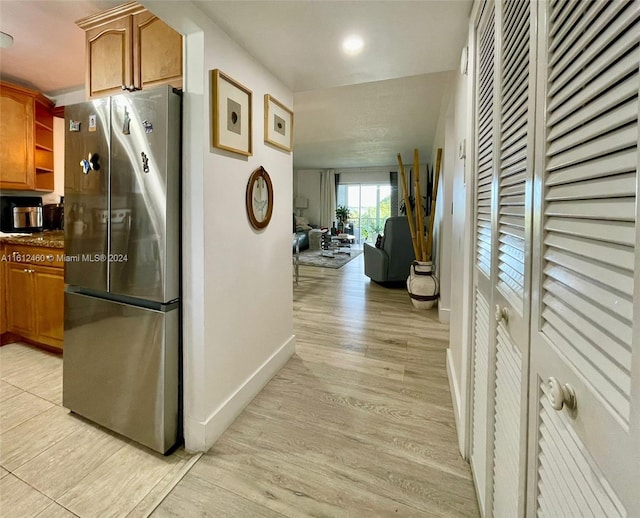 corridor with light hardwood / wood-style floors