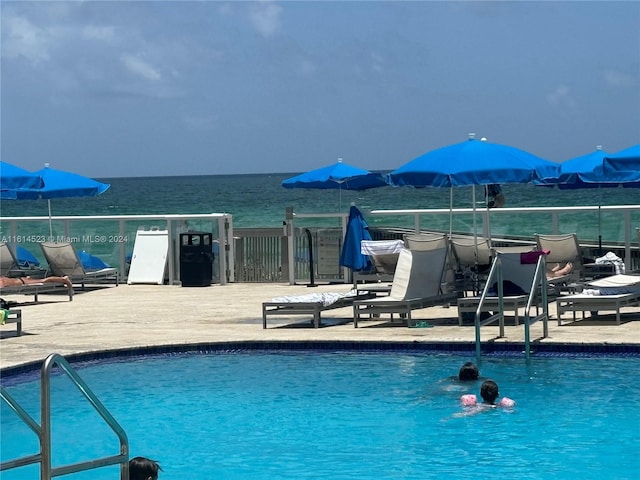 view of swimming pool with a water view