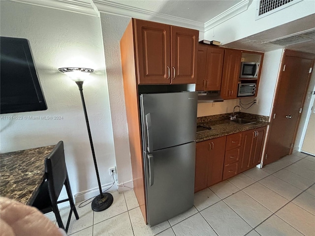 kitchen with crown molding, stainless steel appliances, light tile patterned floors, exhaust hood, and sink