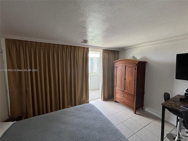 bedroom with a textured ceiling, light tile patterned floors, and crown molding