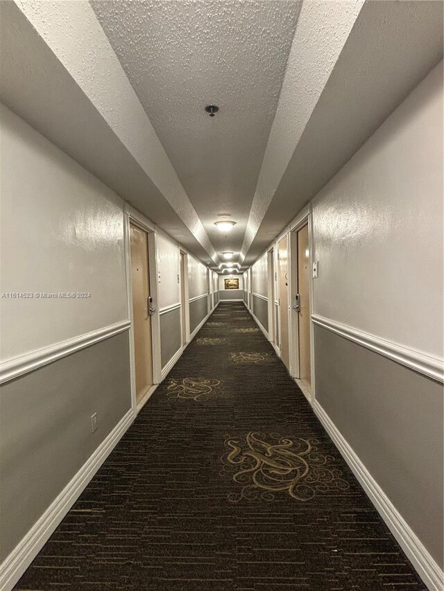 corridor with a textured ceiling