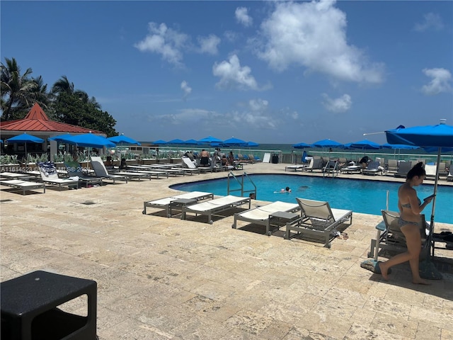 view of pool with a mountain view and a patio