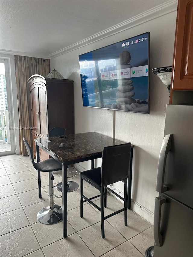 tiled dining space with crown molding