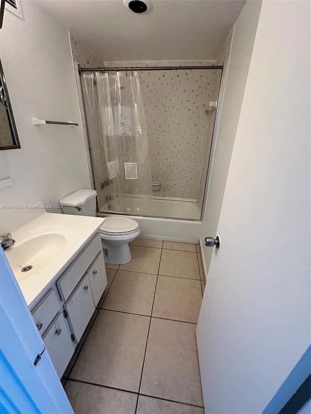 full bathroom with tile patterned flooring, toilet, vanity, and shower / tub combo with curtain