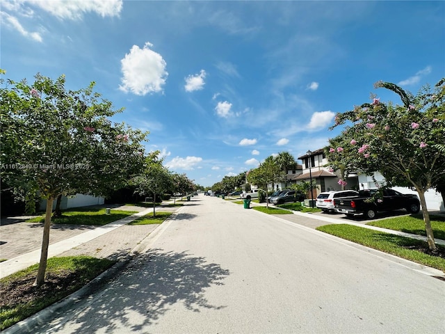 view of street featuring curbs, sidewalks, and a residential view