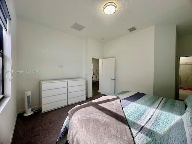 carpeted bedroom featuring a textured ceiling