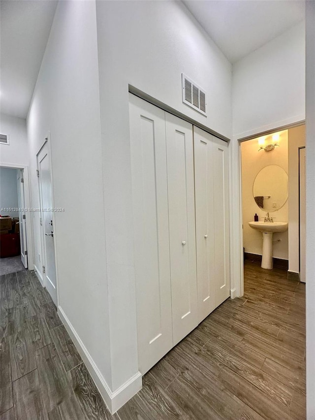 hall featuring dark hardwood / wood-style flooring and sink