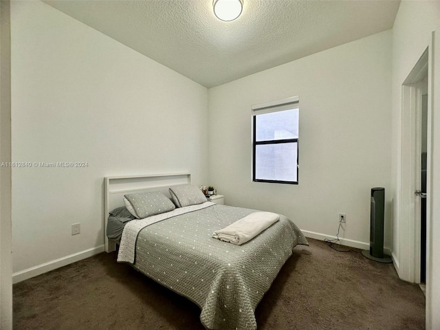 carpeted bedroom with a textured ceiling