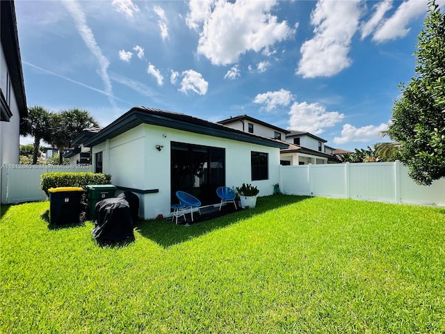 back of house featuring a lawn