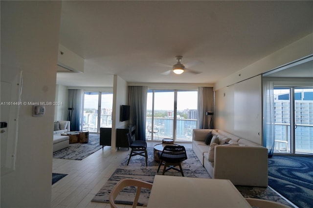 living room featuring ceiling fan and light wood-type flooring