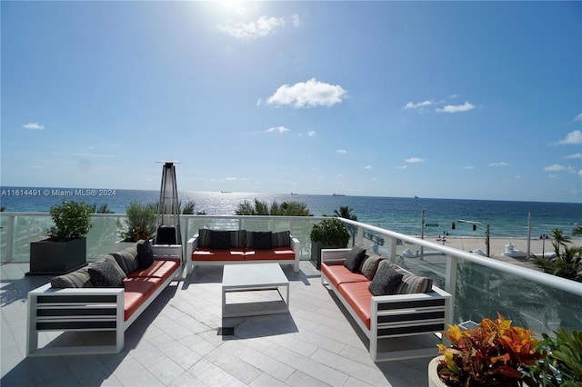 view of patio / terrace with a water view, an outdoor hangout area, and a balcony