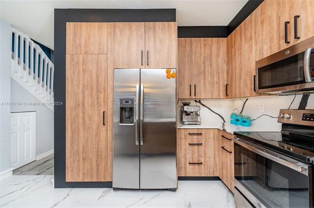 kitchen with light tile patterned floors and appliances with stainless steel finishes