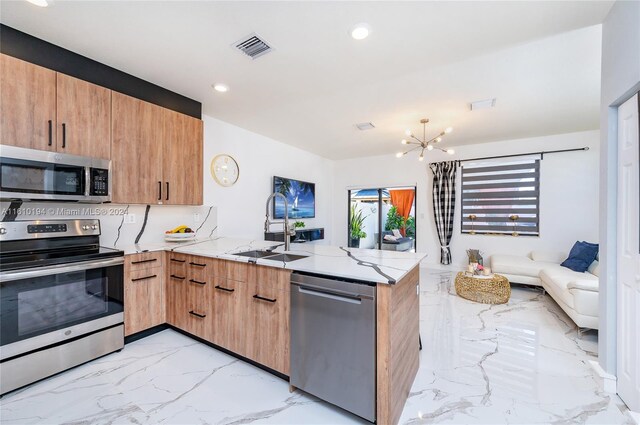 kitchen with an inviting chandelier, stainless steel appliances, light stone countertops, light tile patterned floors, and kitchen peninsula