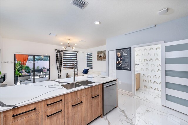 kitchen with hanging light fixtures, a notable chandelier, stainless steel dishwasher, light tile patterned floors, and sink