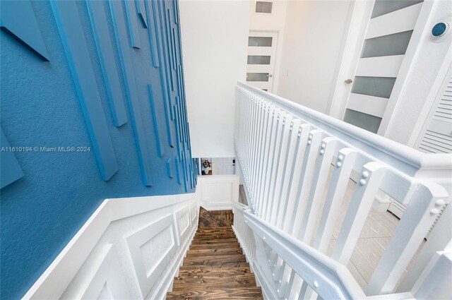 stairway featuring dark wood-type flooring