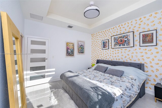 bedroom featuring a raised ceiling