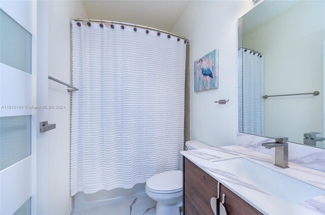 bathroom featuring tile patterned floors, vanity, and toilet