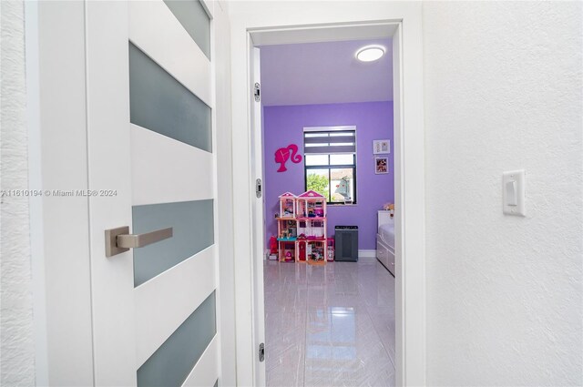 corridor with tile patterned flooring