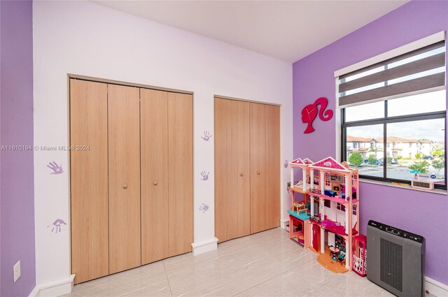 rec room with light tile patterned flooring