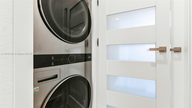 laundry room with stacked washer / drying machine