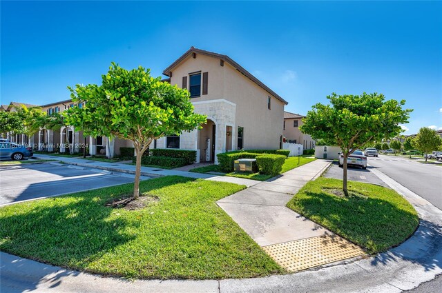 mediterranean / spanish house featuring a front lawn