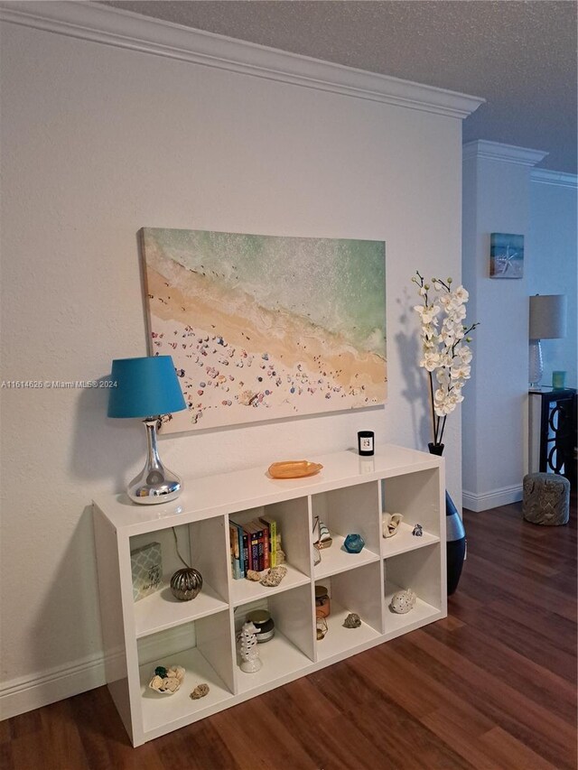 room details featuring crown molding, a textured ceiling, and hardwood / wood-style floors