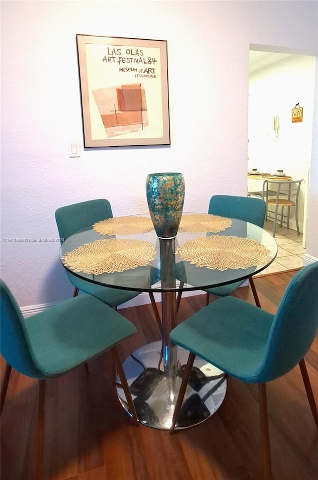 dining space with hardwood / wood-style flooring