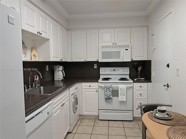 kitchen featuring white appliances, sink, white cabinets, and washer / clothes dryer