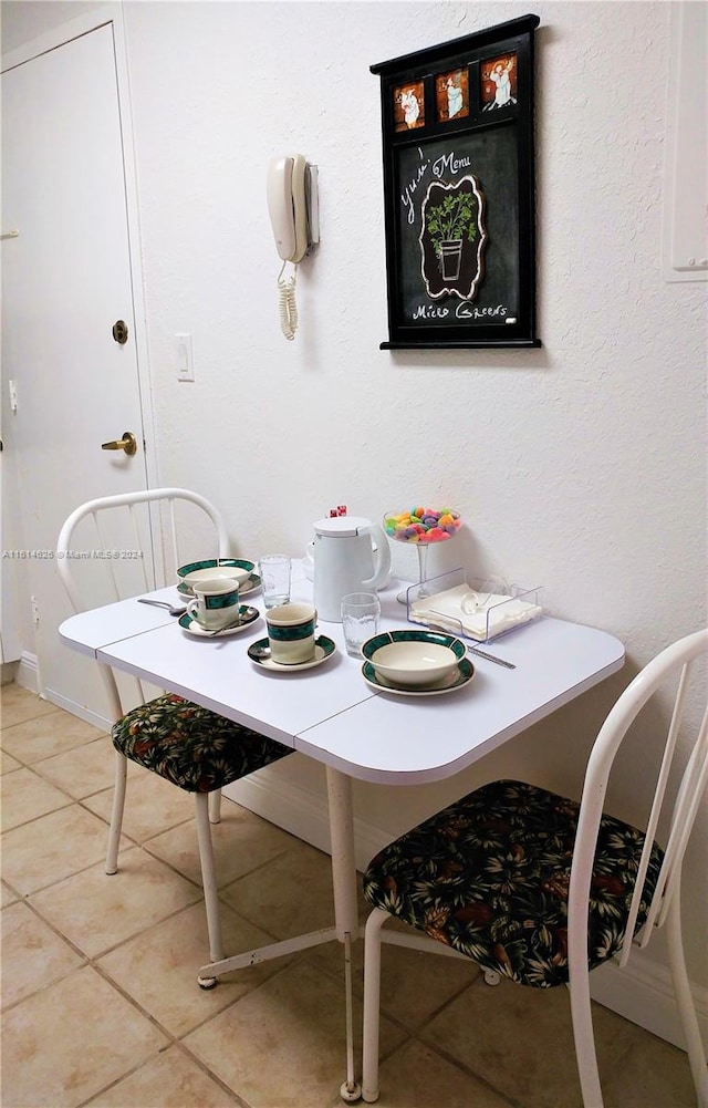 dining space with light tile flooring