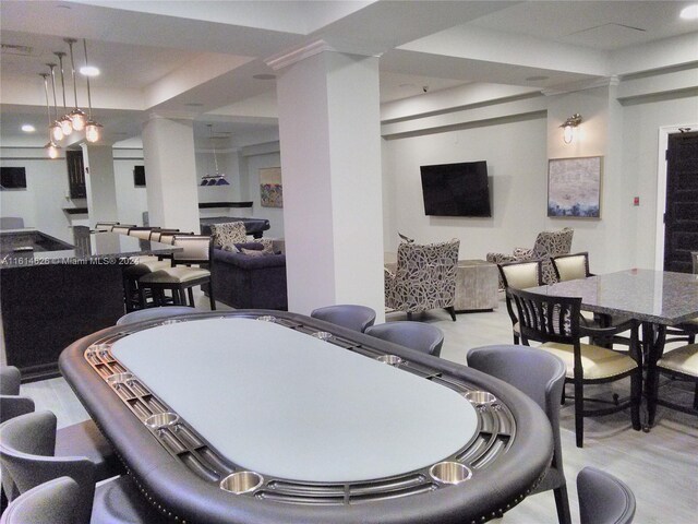 dining room featuring a tray ceiling and light hardwood / wood-style floors