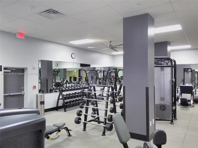 gym featuring a paneled ceiling and ceiling fan