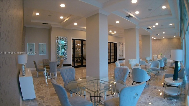 dining area featuring a high ceiling, french doors, ornamental molding, and a tray ceiling