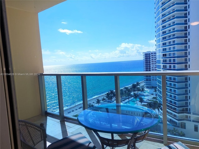 balcony with a water view and a beach view