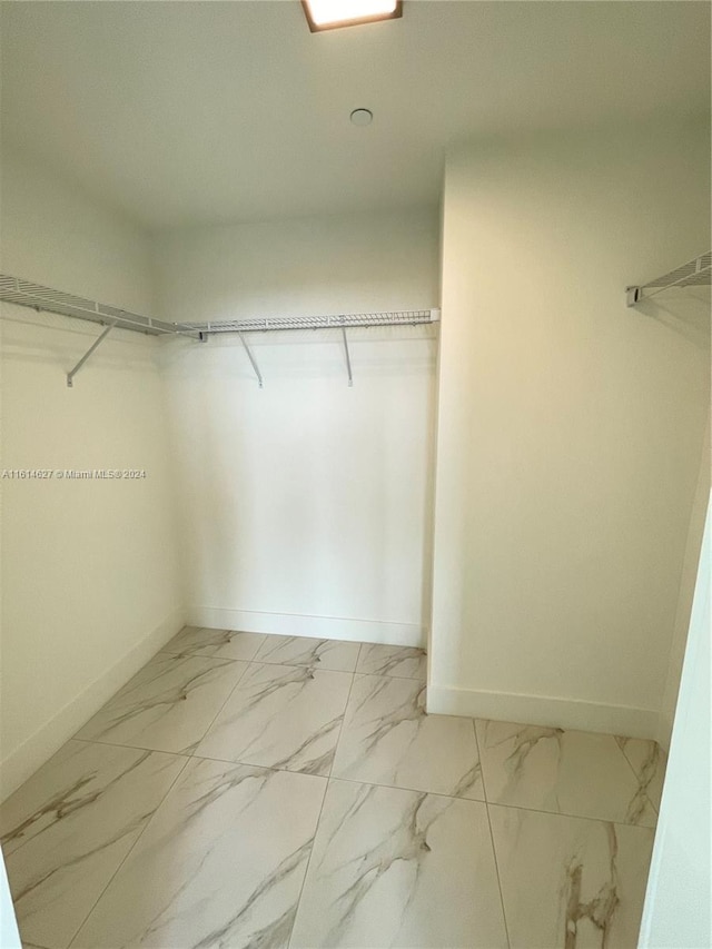 spacious closet featuring tile flooring