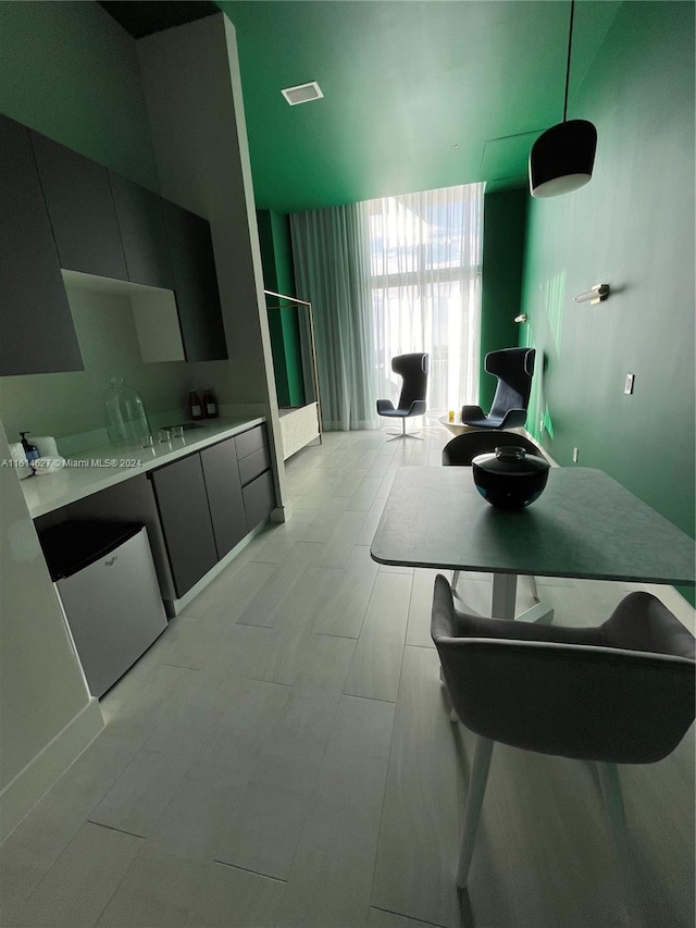 kitchen featuring floor to ceiling windows and light tile flooring