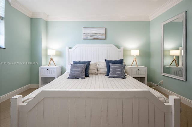 bedroom with crown molding and wood-type flooring