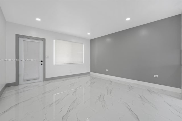 spare room featuring light tile patterned floors