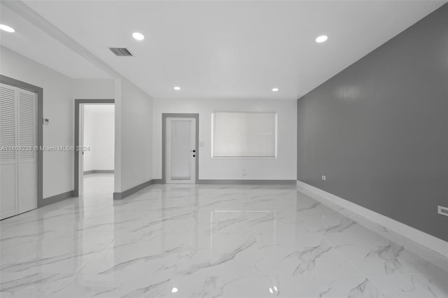 spare room featuring light tile patterned flooring