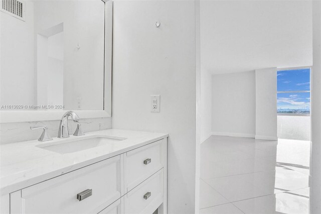 bathroom with tile flooring and vanity