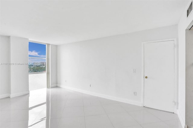 unfurnished room featuring light tile floors