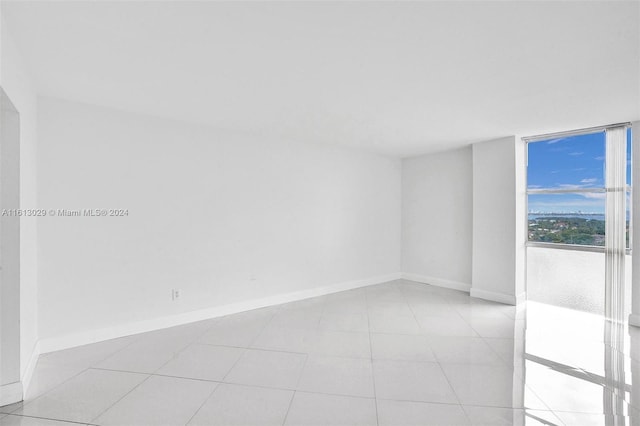 unfurnished room with light tile patterned floors